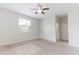Bright, airy bedroom featuring plush carpet, ceiling fan, closet, and a sunlit window at 4928 Cortland Dr, Davenport, FL 33837