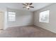 Spacious bedroom with neutral carpet, ceiling fan, and sun-filled windows at 4928 Cortland Dr, Davenport, FL 33837