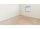 Clean, minimalist bedroom with neutral carpet and a window letting in natural light at 4928 Cortland Dr, Davenport, FL 33837