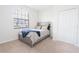 Inviting bedroom featuring a cozy bed, soft carpet, a window and a closet with lots of storage at 4928 Cortland Dr, Davenport, FL 33837