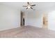 Spacious bedroom with neutral carpet, ceiling fan, walk-in closet and en-suite bathroom at 4928 Cortland Dr, Davenport, FL 33837