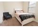 Bright bedroom with a cozy chair, window, and comfortable bed with stylish bedding at 4928 Cortland Dr, Davenport, FL 33837