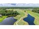 Scenic aerial view of the golf course, featuring lush greenery, water hazards, and serene fairways at 4928 Cortland Dr, Davenport, FL 33837