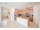 Bright kitchen with stainless steel appliances, island, wood cabinets, and an open layout at 4928 Cortland Dr, Davenport, FL 33837