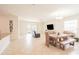 Open living area with dining table, entertainment center and tile flooring offers comfortable living at 4928 Cortland Dr, Davenport, FL 33837