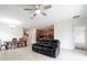 Open concept living space with dining area, tile floors, ceiling fan, and views of the kitchen at 4928 Cortland Dr, Davenport, FL 33837