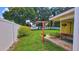 Side yard featuring a cozy swing, potted plants, and a manicured lawn at 518 Oranole Rd, Maitland, FL 32751