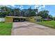 Charming single-story home with a covered parking, lush lawn, and mature trees offering shade at 518 Oranole Rd, Maitland, FL 32751