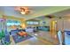 Bright and spacious living room featuring a ceiling fan, large windows, and comfortable seating arrangement at 518 Oranole Rd, Maitland, FL 32751