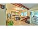 Open-concept living space with exposed beams, open access to a kitchen, and a unique serving bar at 518 Oranole Rd, Maitland, FL 32751