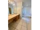 Bathroom featuring vanity area, tile floors, and shower and bathtub combo at 5230 Clarion Oaks Dr, Orlando, FL 32808