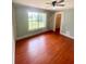 Bedroom with hardwood floors, a ceiling fan, and a large window for natural light at 5230 Clarion Oaks Dr, Orlando, FL 32808