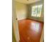 Cozy bedroom with wood-look flooring and a window providing natural light at 5230 Clarion Oaks Dr, Orlando, FL 32808