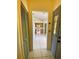 View of a tiled entryway that looks into the kitchen with wood cabinets and white appliances at 5230 Clarion Oaks Dr, Orlando, FL 32808