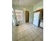 View of the kitchen showing white appliances, a light fixture, and tile flooring at 5230 Clarion Oaks Dr, Orlando, FL 32808