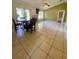 View of a living room showing a fireplace, glass sliding doors, tile floors, and a ceiling fan at 5230 Clarion Oaks Dr, Orlando, FL 32808