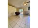 Open-concept living room features a fireplace, large sliding glass doors and tile flooring at 5230 Clarion Oaks Dr, Orlando, FL 32808