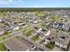 A high view of homes with solar panels in a neighborhood with a pond and trees in the background at 6522 Rover Way, St Cloud, FL 34771