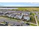 A high shot of a community of two-story homes with a large lake and green space at 6522 Rover Way, St Cloud, FL 34771