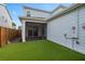 Spacious backyard featuring artificial turf, a covered patio, and exterior siding, offering outdoor living at 6522 Rover Way, St Cloud, FL 34771