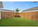Landscaped backyard with artificial turf, privacy fence, and a small palm tree at 6522 Rover Way, St Cloud, FL 34771