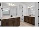Elegant bathroom showcasing double sinks, brown vanities, and a walk-in shower with white subway tiles at 6522 Rover Way, St Cloud, FL 34771