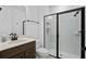 Modern bathroom with a sleek glass-enclosed shower, dark fixtures, and a stylish vanity at 6522 Rover Way, St Cloud, FL 34771