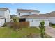 View of the home's exterior, showcasing the solar panels, fenced yard, and two-car garage at 6522 Rover Way, St Cloud, FL 34771
