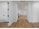 Bright hallway with wood floors leading to an open living area, showcasing the home's spacious layout at 6522 Rover Way, St Cloud, FL 34771