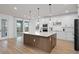 Bright kitchen with a large island, white cabinets, and modern appliances perfect for cooking and entertaining at 6522 Rover Way, St Cloud, FL 34771