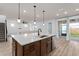 Open kitchen with a large island, stainless steel dishwasher, and easy access to the outdoor patio at 6522 Rover Way, St Cloud, FL 34771