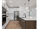 Contemporary kitchen showcasing a center island with sink, stainless steel appliances, and modern fixtures at 6522 Rover Way, St Cloud, FL 34771