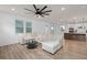 Bright living room with a large sectional sofa, open layout, and seamless access to the modern kitchen at 6522 Rover Way, St Cloud, FL 34771