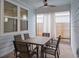 Covered patio with neutral colors, featuring a ceiling fan and a dining table with seating for outdoor enjoyment at 6522 Rover Way, St Cloud, FL 34771