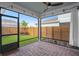 Covered patio with brick pavers, a ceiling fan, and a view of the fenced backyard with artificial turf at 6522 Rover Way, St Cloud, FL 34771