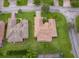 A high-angle shot showing the beautiful tile roof and well-maintained landscaping at 730 Villa Park Rd, Poinciana, FL 34759