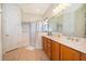 Bright bathroom featuring a double sink vanity, glass shower, and tile floors at 730 Villa Park Rd, Poinciana, FL 34759