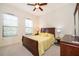 Bedroom with a queen-sized bed, ceiling fan, and abundant natural light at 730 Villa Park Rd, Poinciana, FL 34759