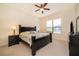 Spacious bedroom featuring a king-sized bed, ceiling fan, and a large window at 730 Villa Park Rd, Poinciana, FL 34759