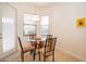 Breakfast nook with tile floor, round glass table with four chairs, and natural light at 730 Villa Park Rd, Poinciana, FL 34759