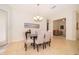 Dining room with seating for six, modern lighting, and easy access to the outdoor area at 730 Villa Park Rd, Poinciana, FL 34759