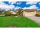 Charming home featuring a lush green lawn and inviting curb appeal at 730 Villa Park Rd, Poinciana, FL 34759