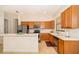 Bright kitchen featuring wood cabinetry, stainless steel appliances, white countertop, tile flooring at 730 Villa Park Rd, Poinciana, FL 34759