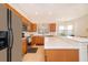 Bright kitchen featuring wood cabinetry, tile flooring, stainless steel appliances and breakfast bar at 730 Villa Park Rd, Poinciana, FL 34759
