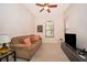 Cozy living room with a comfortable sofa, television, and neutral decor at 730 Villa Park Rd, Poinciana, FL 34759