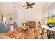 Cozy living room features comfortable seating, a decorative rug, and natural light from large window at 730 Villa Park Rd, Poinciana, FL 34759