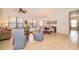 Open-concept living room with tile flooring, neutral colors, and a dining area at 730 Villa Park Rd, Poinciana, FL 34759