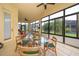 Enclosed patio featuring tile floors, ceiling fans, and views of the surrounding landscape at 730 Villa Park Rd, Poinciana, FL 34759