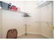 Spacious walk-in closet features neutral carpeting, shelving, and hanging storage for optimal organization at 730 Villa Park Rd, Poinciana, FL 34759