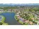 Stunning aerial view of a community by a large lake, showcasing neighborhood layout and proximity to the water at 746 Stonewyk Way, Kissimmee, FL 34744